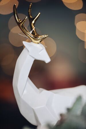 Close up of white deer figurine on the festive table. New Year eve conceptの写真素材