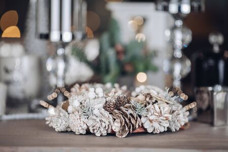 Christmas and New Year holidays concept with pine cone wreath on tableの写真素材