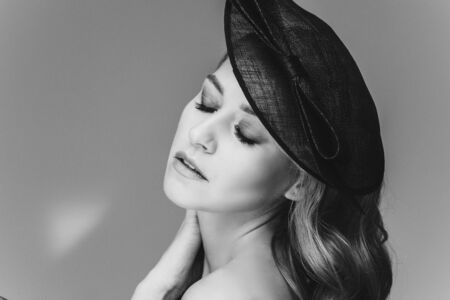 Stunning lady with natural makeup in black hat.の写真素材