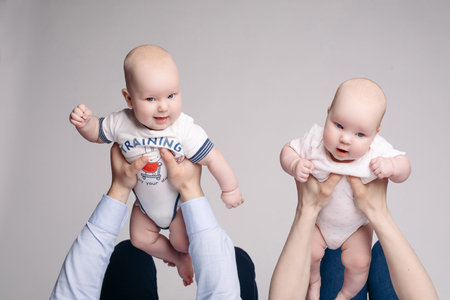 Parents holds their children on hands and pick them up