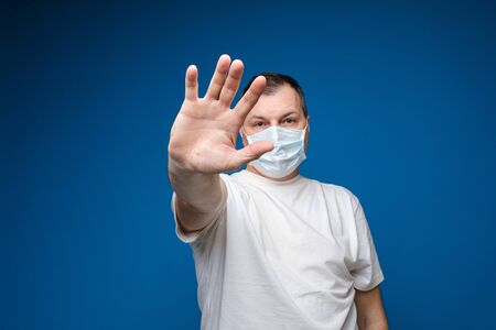 Calm man medic in protective face mask in studioの写真素材