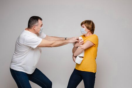 A couple in love hugs together and stands in medical masks, portrait isolateed on white backgroundの写真素材