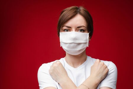 Woman in aseptic mask with crossed arms on her chest.の写真素材