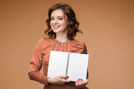 Smiling woman with open book. She is smiling at camera.の写真素材