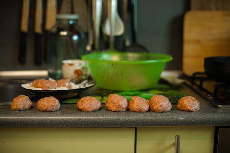 Cooking meatballs, ready mince lies by roasting on the kitchen tableの写真素材