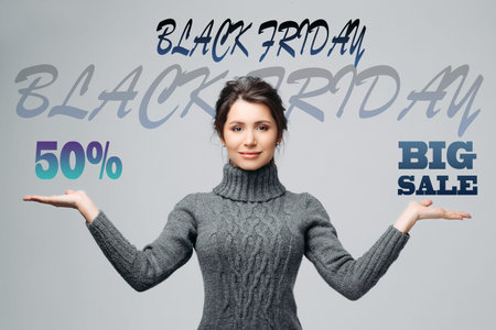 Young beautiful girl keeps the balance between discounts on the advertising banner