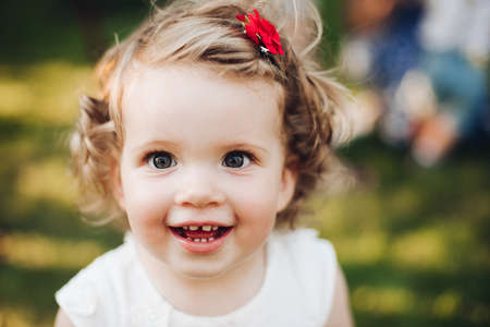 Happy adorable little girl is playing outsideの写真素材