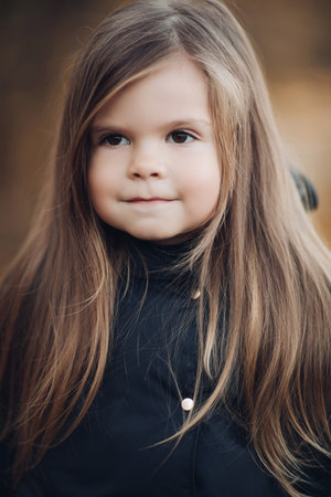 Portrait of cute little girl with long hair and hazel eyes medium close up