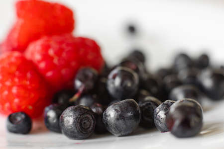 Summer berries in close up on white.の写真素材