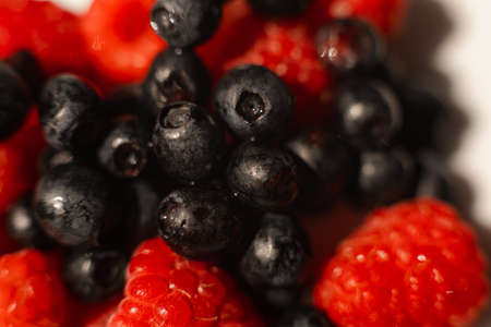 Black currant and raspberries pile.の写真素材