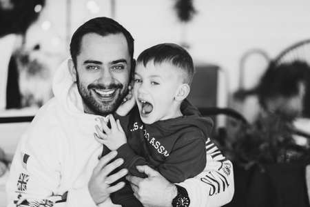 :Happy dad and children Portrait of smiling young family on Christmas day. Togetherness conceptのeditorial素材