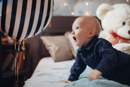 little pretty boy lies on the bedの写真素材
