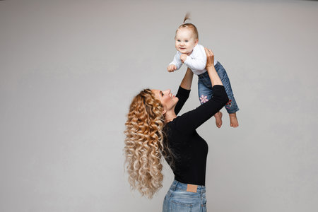 Mother playing with baby daughter.