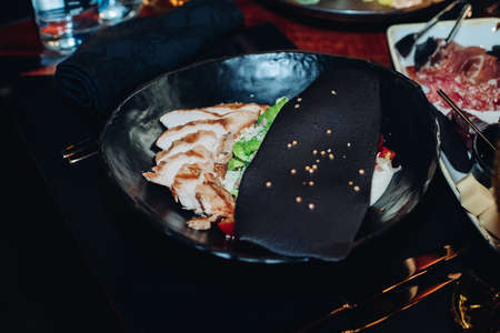 Caesar salad in stylish black bowl.の写真素材