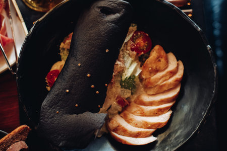 Delicious meal in large black bowl on the table