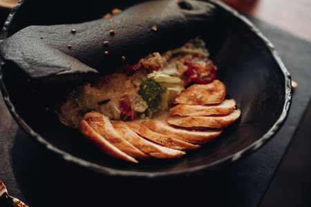Tasty food in the restaurant served in black bowl