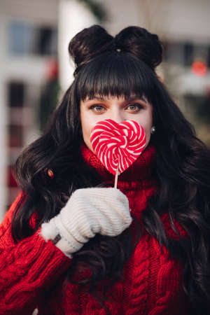 Beautiful woman with red lollipop.の写真素材