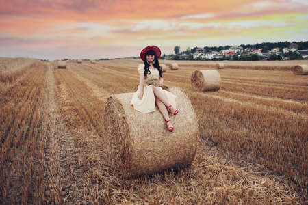 Pretty lady on the haystack.の写真素材