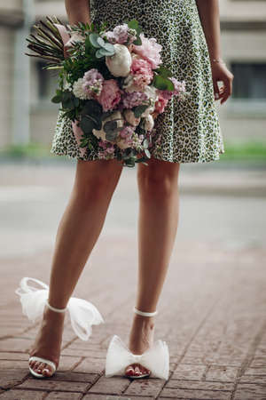 picture of slim woman in green dress holding a boquet of flowersの写真素材