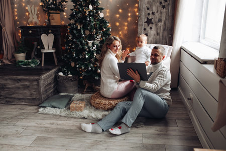 Family using laptop at Christmas.の写真素材