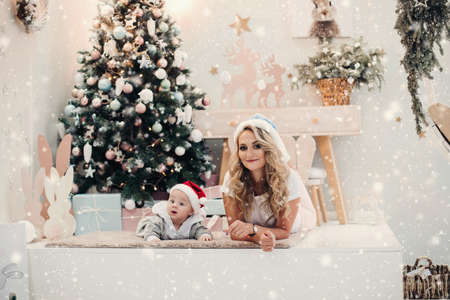 Mom in Snow Maiden hat and son in Santa hat.の写真素材