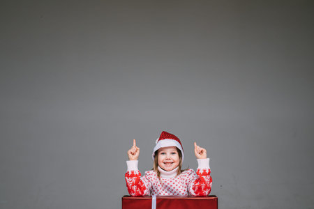 Girl in Santa hat having an idea.