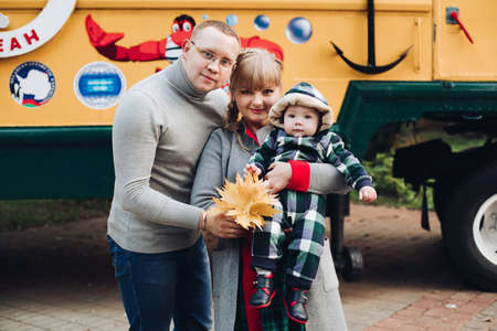 Beautiful and happy family with little child in park.の写真素材