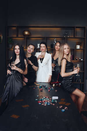 Gorgeous sexy ladies at poker table with drinks.の写真素材