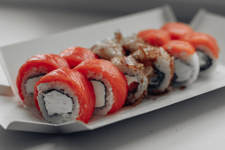 Beautiful delicious sushi. Sushi delivery. Advertising sushi rolls made of fish and cheese.の写真素材