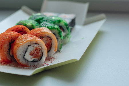 Beautiful delicious sushi. Sushi delivery. Advertising sushi rolls made of fish and cheese.