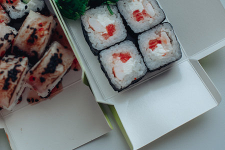 Beautiful delicious sushi. Sushi delivery. Advertising sushi rolls made of fish and cheese.