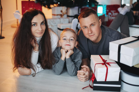 A family around the Christmas tree in the new year, a holiday with family,a beautiful happy stylish...