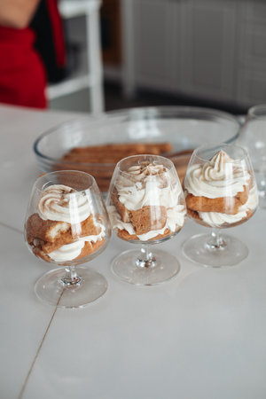 A beautiful dessert, tiramisu in a glass, several guests.の写真素材
