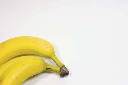 Three yellow bananas on white backgroundの写真素材