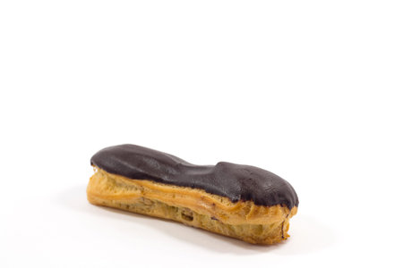 One long yummy eclair with chocolate isolated on a white background.