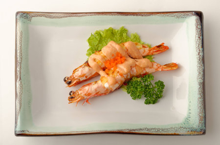 Grilled shrimp served on a glazed plateの写真素材
