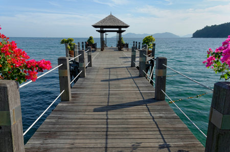 Sky and ocean at the end of a wooden pier.の写真素材
