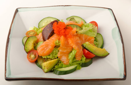 Raw salmon and avocado salad on a square plate.の写真素材