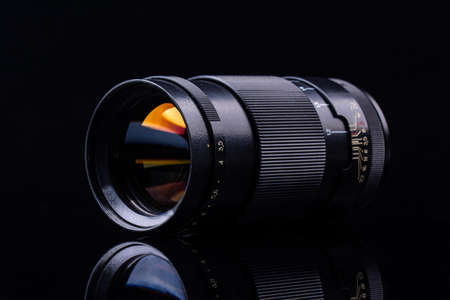 Camera lens only on black background with reflectionの写真素材