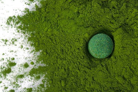 Vitamin and mineral supplements for vegetarians spirulina in tablets on a white background, close-up.の写真素材