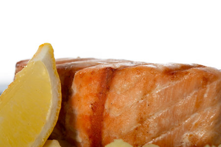 Grilled salmon fillet in a plate with lemon, isolate. Photo for advertising.