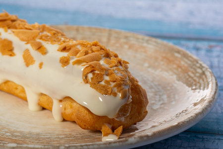 Traditional French eclairs stuffed with vanilla cream and powdered sugar.