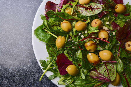 Fresh vegetables, salad, mix, lettuce, leaves salad on a blue stone backgroundの写真素材
