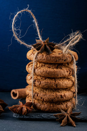 Oatmeal cookies tied with twine on a blue background. Food, holiday, cooking, baking background.