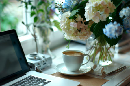 Morning light streams through the window, illuminating a warm cup of coffee beside a delicate bouquet of hydrangeas, creating a peaceful atmosphere perfect for work or relaxation.の素材