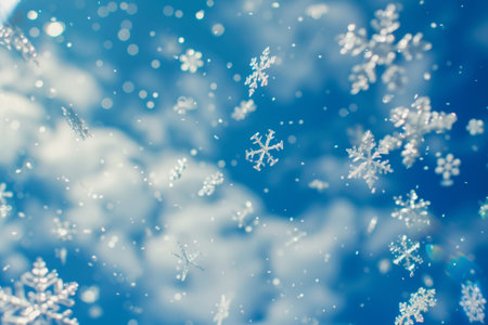 Soft snowflakes gracefully drift through the clear blue sky, contrasting against fluffy clouds, embodying the serene beauty of winter. The enchanting scene invites a sense of peace and wonder.の素材