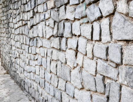 Gray wall of stone along. Abstract psychological barrier to the problem.