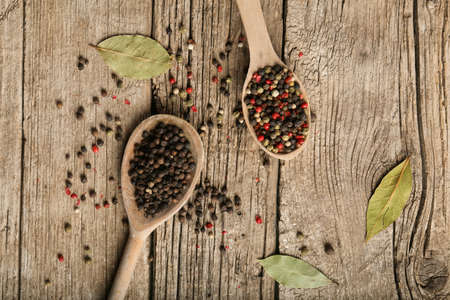 Peppercorn with wooden spoon on old wooden background texture. Close Up of peppercorn in wooden spoon on old wooden table.の写真素材