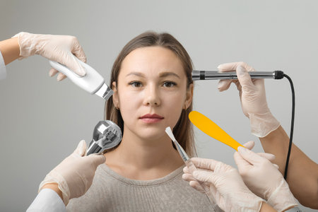 Face and body treatments. The concept of maintaining health, youth and beauty. Face masks, modern cosmetology, beautician tools, hands with gloves. Beauty techniques.の写真素材