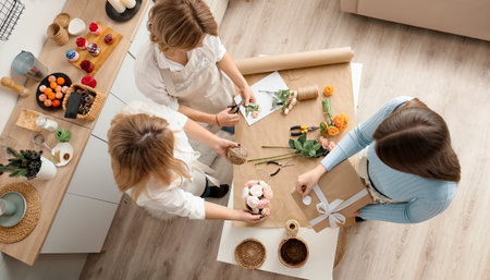 Girl makes flowers from the soap. Hobby, creative process. DIY gifts. Women's hands and flowers. Handmade soap. Mother's Day, Women's Day. Natural organic products. Flowers on a white table.の写真素材